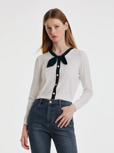a lady in white petite size bow-knot sweater